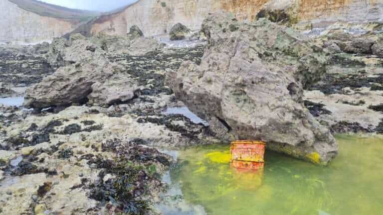 A member of the public raised the alarm on Saturday after spotting a container in the sea at Hope Gap near Seaford, which was leaking an unidentified yellow substance.