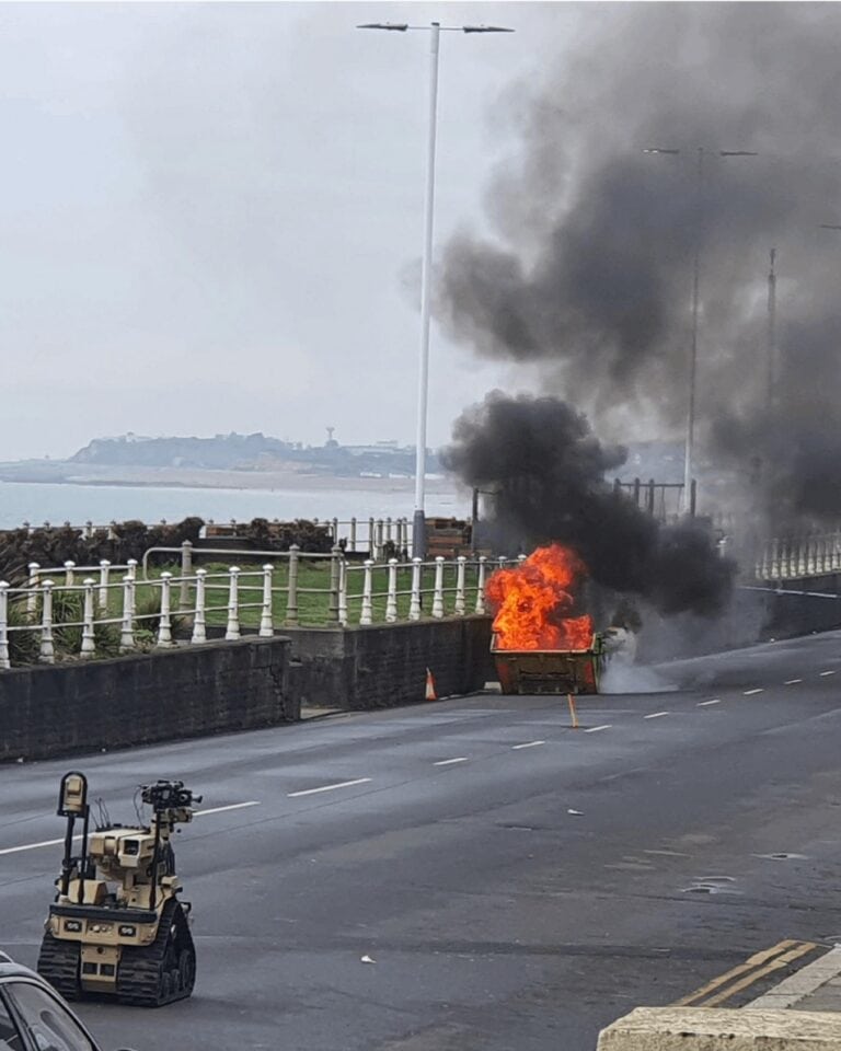 EOD carry out controlled burn by sea wall as searches continue for unknown chemicals; 28-year-old man detained under Mental Health Act.